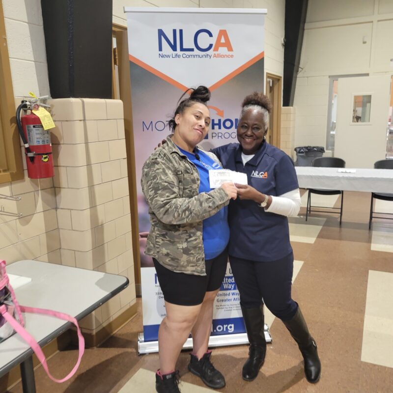 One Motel to Home client receives a check to move in to her own apartment.