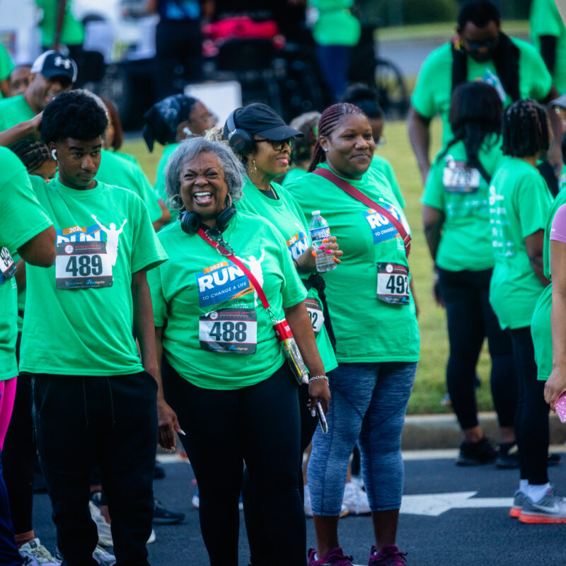 Families and community members participating in a wellness-focused walk and community fitness event in South DeKalb